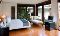 Bedroom with Wooden Floor and TV - Villa Ramadewa - Seminyak, Bali